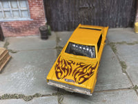 Yellow 1967 Dodge Charger custom Hot Wheels with flame graphics, view 3