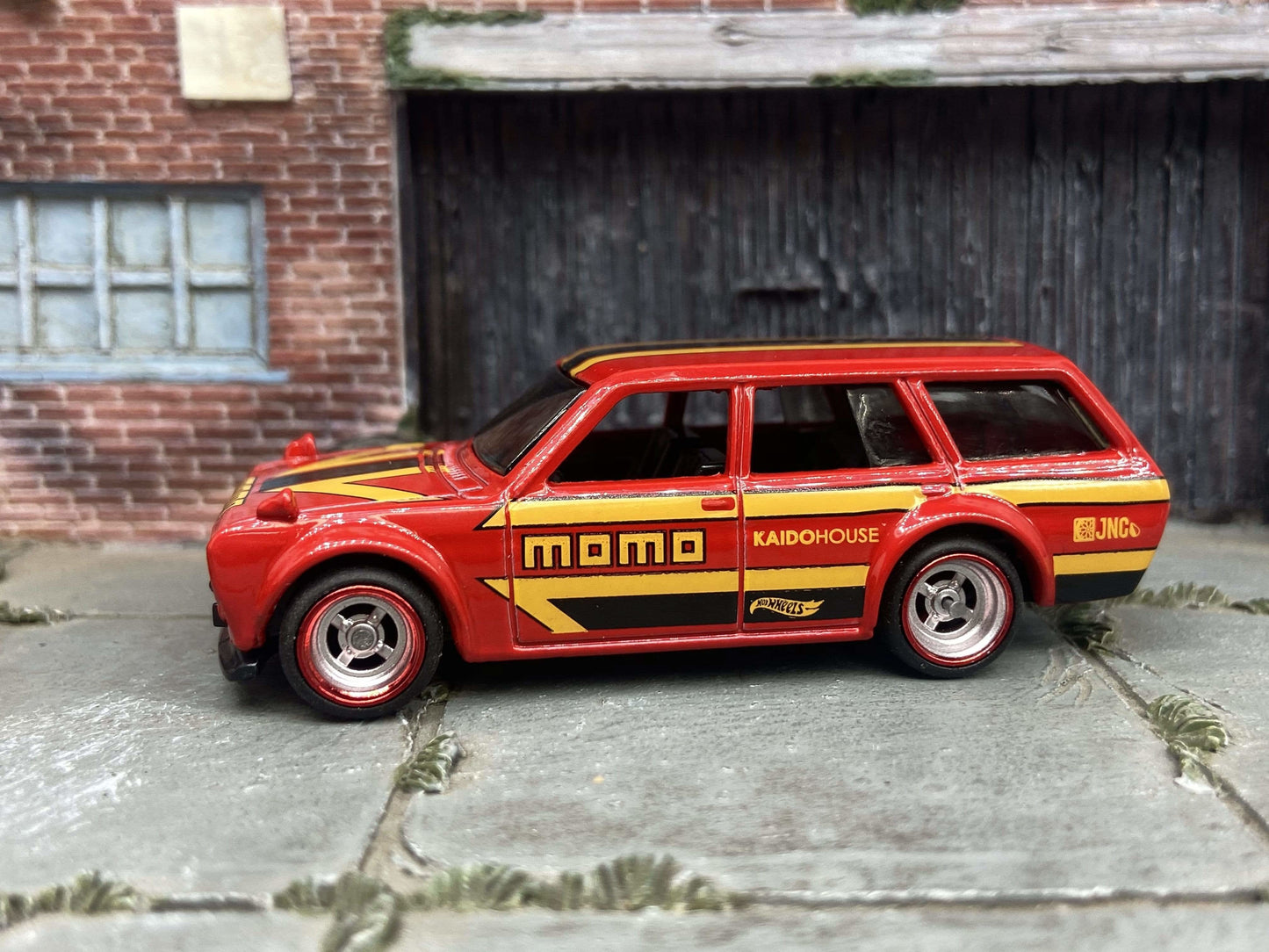Custom Hot Wheels 1971 Datsun 510 Wagon In MOMO Red Yellow Black With Chrome and Red 4 Spoke Race Wheels With Rubber Tires