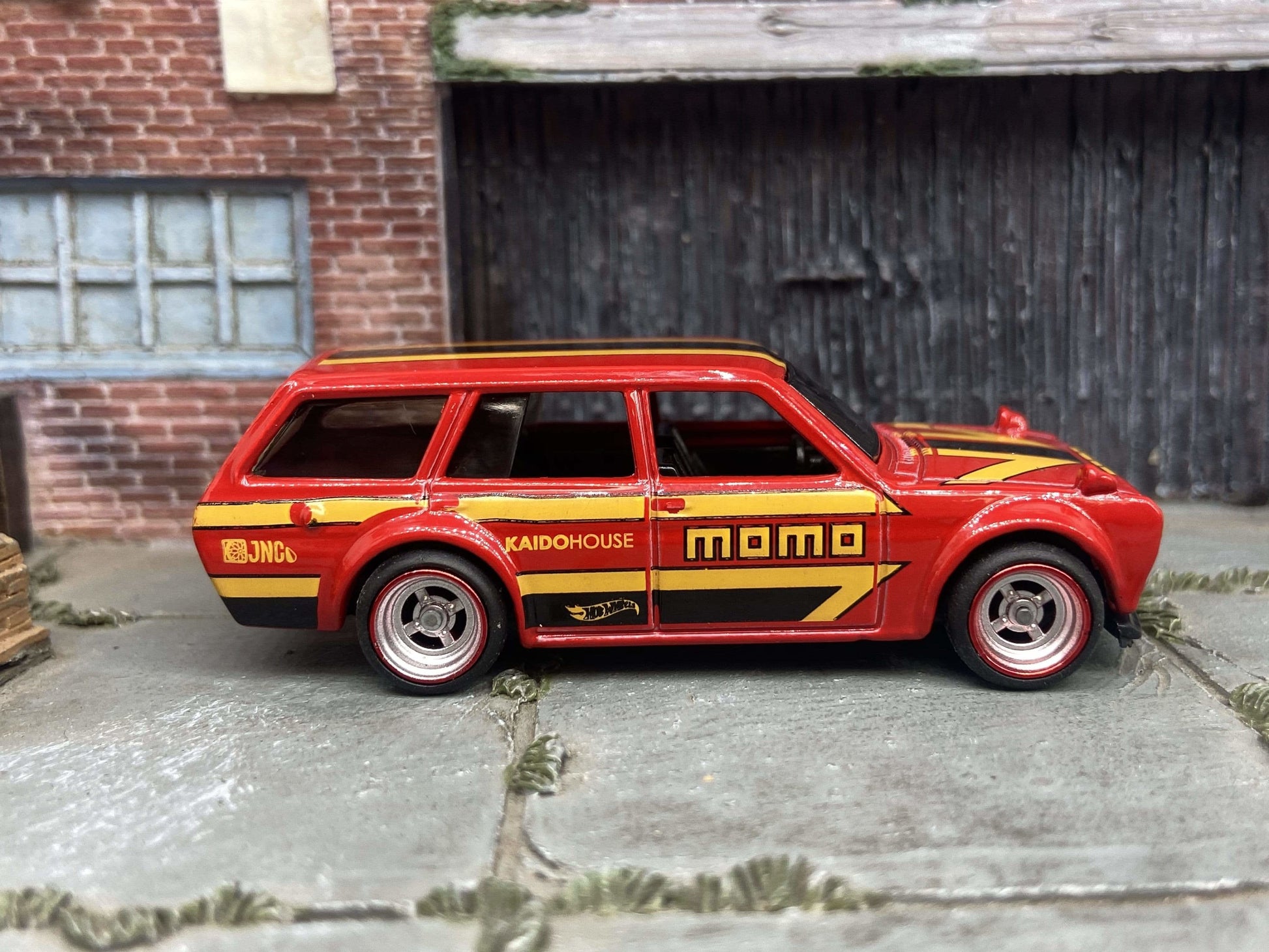 Custom Hot Wheels 1971 Datsun 510 Wagon In MOMO Red Yellow Black With Chrome and Red 4 Spoke Race Wheels With Rubber Tires