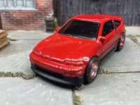 Side view of red 1988 Honda CRX custom Hot Wheels with chrome-and-red wheels