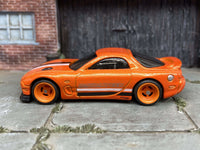 Orange 1995 Mazda RX-7 custom Hot Wheels with orange wheels, view 1