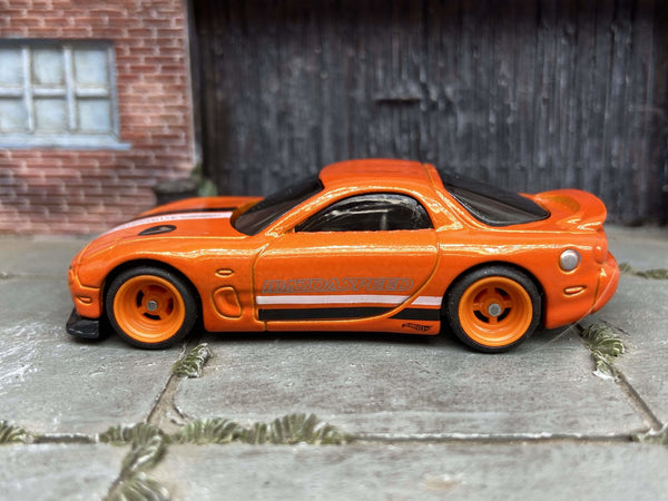 Orange 1995 Mazda RX-7 custom Hot Wheels with orange wheels, view 1