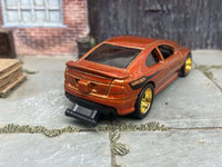 Burnt-orange 2006 Pontiac GTO custom Hot Wheels with gold wheels, view 2