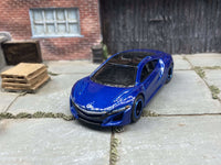 Side view of blue 2017 Acura NSX custom Hot Wheels with black-and-blue wheels