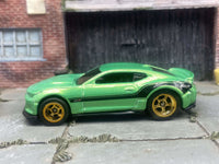 Rear three-quarter view of green-and-black Camaro ZL1 with rubber tires