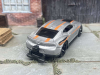 Side view of silver Camaro COPO custom Hot Wheels with black deep-dish wheels