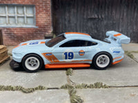 Rear three-quarter view of 2018 Mustang GT custom Hot Wheels with white race wheels