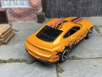 Side view of orange 2018 Mustang GT custom Hot Wheels with black-and-chrome wheels