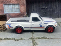 Front three-quarter view of white-and-red Datsun 620 custom Hot Wheels