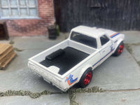 Side view of Datsun 620 custom Hot Wheels with red 5-star wheels