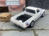 Side view of white Datsun 620 custom Hot Wheels with chrome wheels