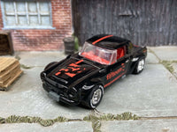 Rear three-quarter view of black-and-red Fairlady 2000 with Yokohama tires