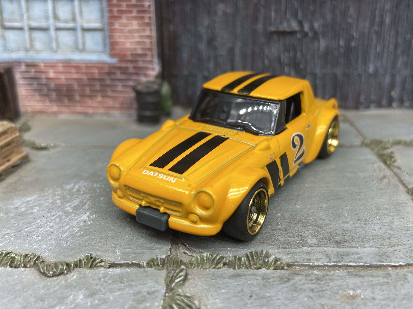 Custom Hot Wheels Fairlady 2000 In Orange and Black With Black and Gold 4 Spoke Race Wheels With Rubber Tires