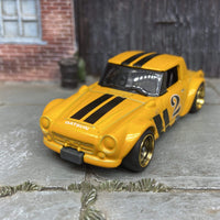 Custom Hot Wheels Fairlady 2000 In Orange and Black With Black and Gold 4 Spoke Race Wheels With Rubber Tires