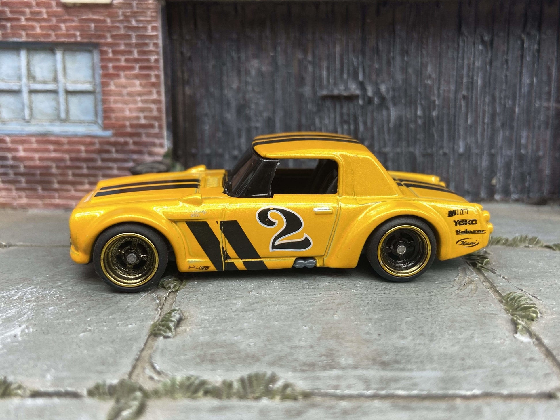 Custom Hot Wheels Fairlady 2000 In Orange and Black With Black and Gold 4 Spoke Race Wheels With Rubber Tires