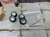 Four 12mm silver AR-style wheels with black rubber tires, view 2