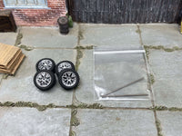 Four 12mm silver FR500-style wheels with black rubber tires, view 2