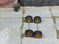 Overhead view of 10mm gold deep-dish wheels with red-line tires on two axle rods