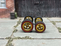 Front view of staggered gold five-spoke deep-dish wheels with red-line tires