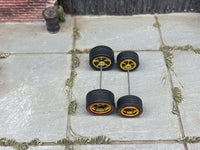 Overhead view of 10mm and 12mm gold deep-dish wheels on two axle rods
