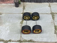 Overhead view of 12mm gold deep-dish wheels with red-line tires on two axle rods