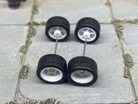Alternate view of white 5-spoke deep-dish wheels with rubber tires