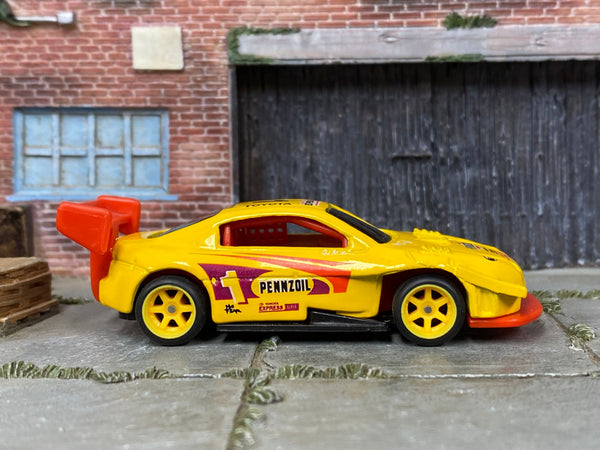 Custom Hot Wheels Pikes Peak Toyota Celica in Pennzoil Yellow with yellow race wheels and rubber tires