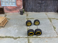 Alternate view of four black-and-gold 5-spoke wheels with black rubber tires