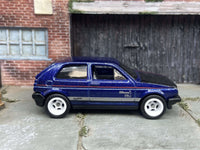Blue and black VW Golf MK2 custom Hot Wheels with white wheels, view 1