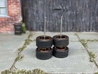 Alternate view of black-and-gold 5-spoke wheels with rubber tires