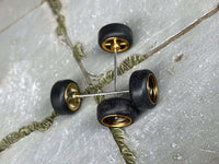 Overhead view of black and gold wheels showing rear hubs and crossing axle rods