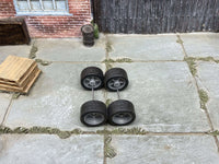 Alternate view of four 12mm gray racing 5-spoke wheels with black rubber tires