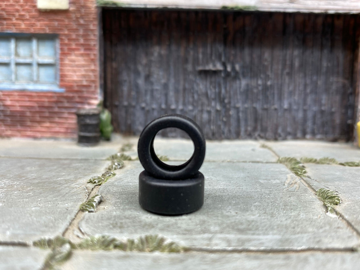 Two 12mm plain drag slick rubber tires shown without wheels