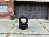 Two 12mm plain drag slick rubber tires shown without wheels