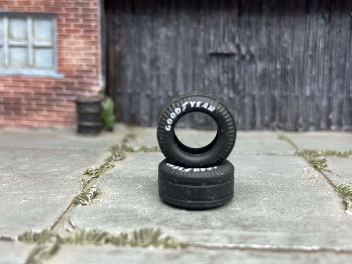 Two 13mm Goodyear-lettered drag slick rubber tires, view 1