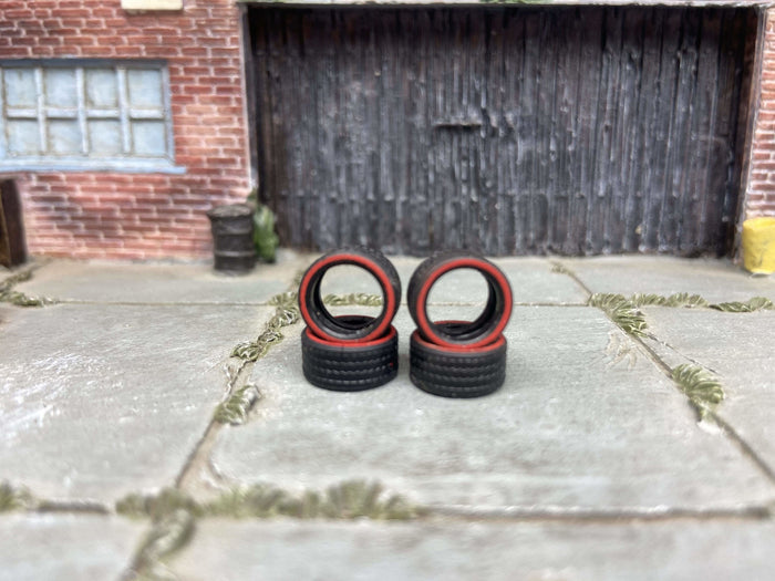 Four 10mm red-line treaded rubber tires without wheels, view 1