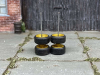 Alternate view of mustard-yellow 4-spoke wheels with rubber tires