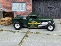 Custom Matchbox 1935 Ford pickup hot rod in satin green with chrome mag wheels and rubber tires, side profile showing the door graphics