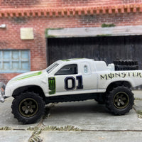Custom Painted Hot Wheels Toyota Tacoma Off Road in Custom White Monster Energy Racing Livery With Green 5 Star Racing Wheels With off Road Rubber Tires