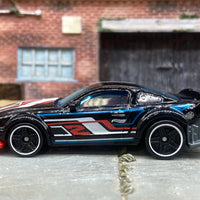 Loose Hot Wheels 2005 Ford Mustang Race Car Dressed in Black, White and Red