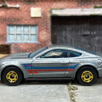 Loose Hot Wheels 2015 Ford Mustang GT Dressed in Silver, Blue and Red