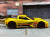 Loose Hot Wheels Chevy Corvette C6-R Race Car Dressed in Yellow, Red and Black 3