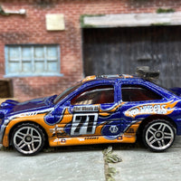 Loose Hot Wheels Ford Escort Rally Dressed in Blue and Orange #71 Race Livery