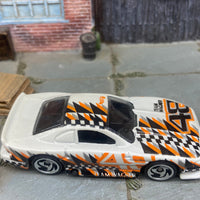 Loose Hot Wheels Ford Mustang Cobra Race Car Dressed in White, Black and Orange