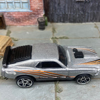 Loose Hot Wheels Ford Mustang Mach 1 Dressed in Silver with Black and Orange Scallops