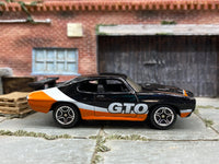 Matchbox 1970 Pontiac GTO Black, Orange and White - rear angle view showing tampo details
