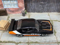 Matchbox 1970 Pontiac GTO Black, Orange and White loose diecast - side profile detail shot