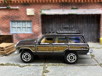 Matchbox 1989 Jeep Wagoneer Dark Gray - rear angle view showing tampo details