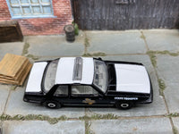 Matchbox 1993 Ford Mustang LX SSP Coupe Black and White Texas State Trooper loose diecast - side profile detail shot