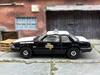 Matchbox 1993 Ford Mustang LX SSP Coupe Black and White Texas State Trooper - rear angle view showing tampo details